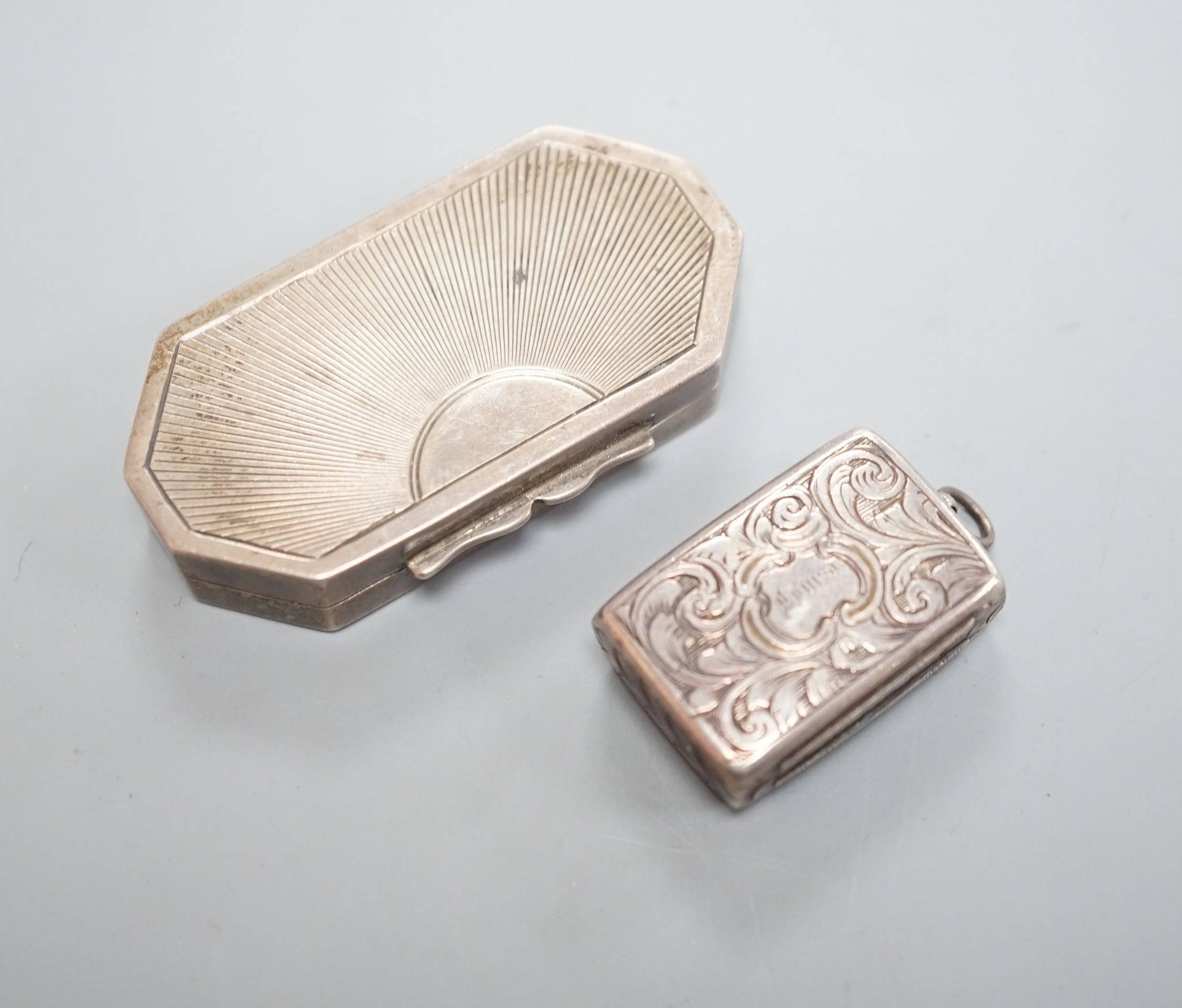 An Edwardian silver octagonal vinaigrette, with engraved sunburst decoration, maker, B.C Birmingham, 1906, 51mm and a smaller earlier vinaigrette by George Unite.